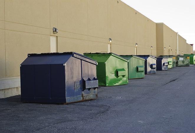 a group of dumpsters lined up along the street ready for use in a large-scale construction project in Centennial